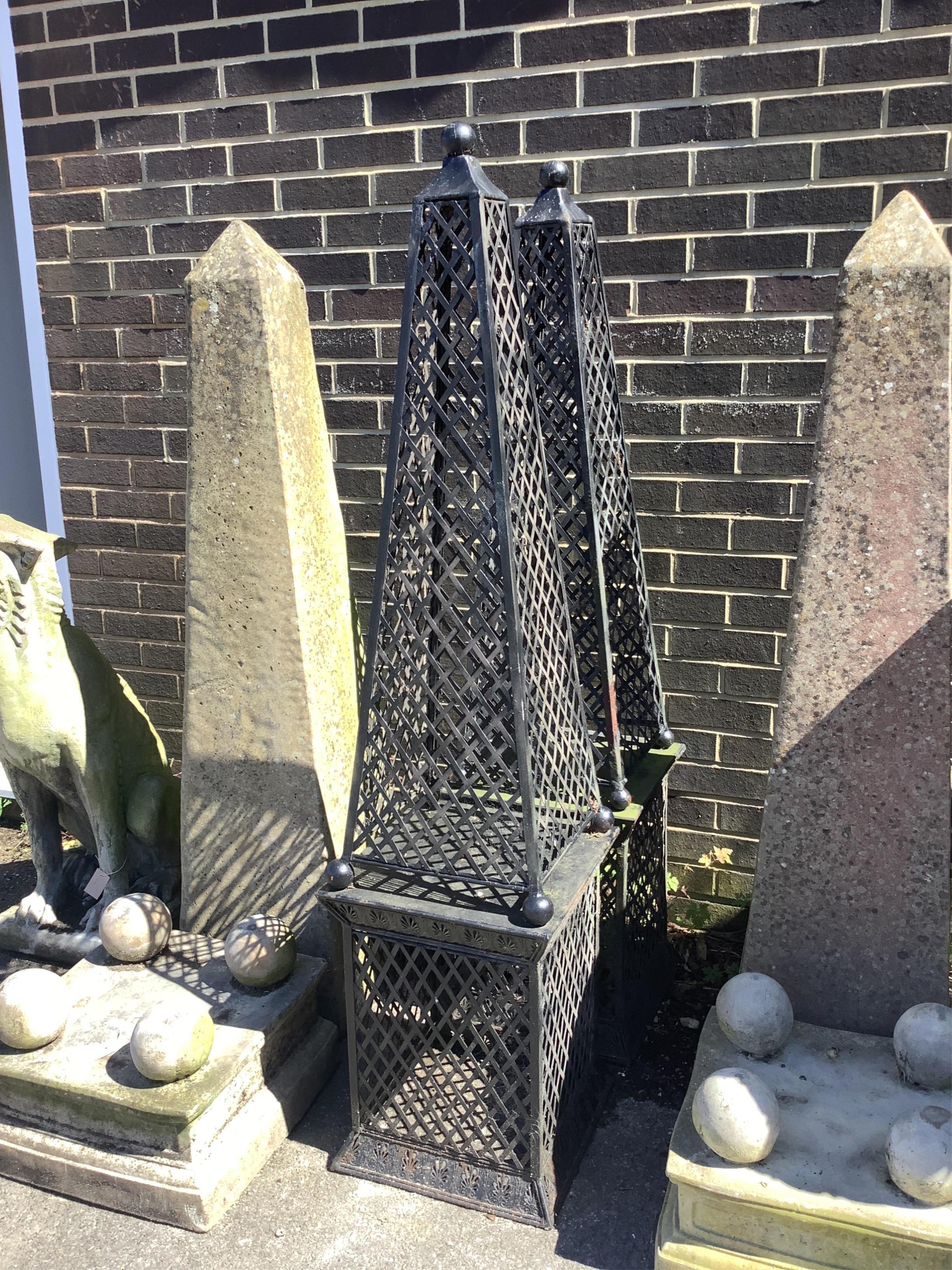 A pair of metal obelisk garden ornaments, height 160cm. Condition - fair